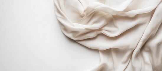 Elegant draped natural blouse fabric on a clean white background showcasing minimal style and texture for fashion and design concepts
