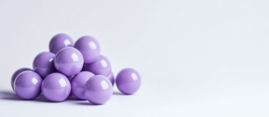 Purple spheres arranged on a minimalist background creating an empty space ideal for text placement and modern design elements.