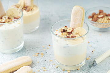 Milk mousse dessert with nuts in glasses