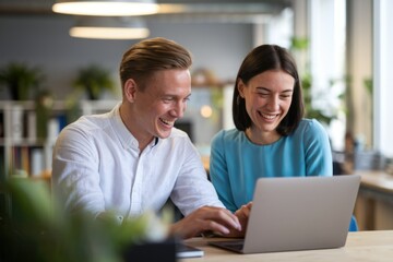 Obraz premium Two smiling colleagues collaborate on a laptop, enjoying teamwork and a shared success.