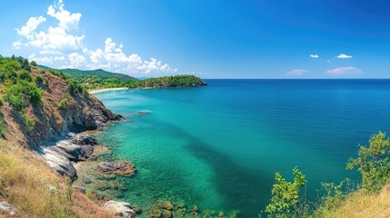 Fototapeta premium Tropical beach panorama with turquoise ocean and clear blue sky under bright summer sunlight showcasing serene natural beauty.