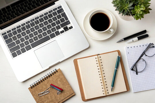 Top-down view of a tidy office desk with a laptop, coffee cup, and productivity tools