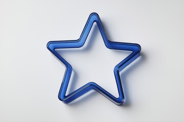 Obraz premium A vibrant blue star-shaped frame, possibly a cookie cutter or decorative element.