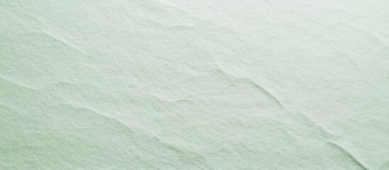 Obraz premium Pale green textured paper background for artistic and design applications showcasing subtle surface details and color variations.