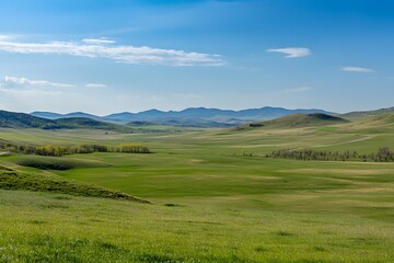 Spring grassland valley panorama, distant mountains, sunny day, nature background, travel