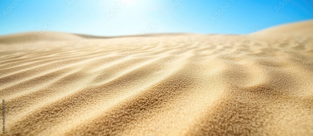 Aufkleber Mesmerizing sand texture background featuring gentle dunes under a bright blue sky creating a serene and tranquil desert landscape.