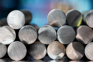 Stack of metal rods in an industrial setting and lighting, metallurgical industry products
