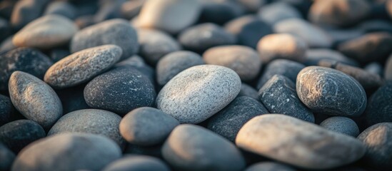 Textured surface of various construction pebbles and gravel in gray tones creating a natural background for design projects or landscaping.