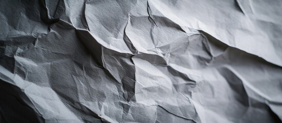 Fototapeta premium Crumpled gray paper texture with natural shadows for backgrounds and design projects