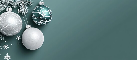 Christmas stationery layout with gray card and festive ornaments on green background for empty text space and seasonal design elements