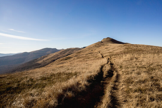 Scenic autumn landscapes from a trekking loop in Bieszczady, featuring views from Tarnica, Halicz, Rozsypaniec, Bukowe Berdo, Połonina Wetlińska, and the Ukrainian Bieszczady under a clear blue sky