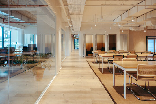 Modern coworking office space interior with open seating and glass partitions