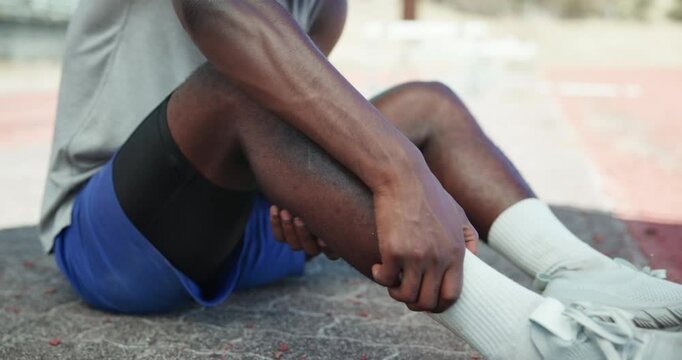 Runner, legs and pulled calf in street with injury, fatigue and sprain with inflammation in city. Person, athlete and burnout with fitness, workout and hands for muscle ache on sidewalk in Kenya