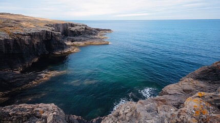 Fototapeta premium Coastal rocky shoreline with clear blue waters and gentle waves creating an idyllic natural landscape : Generative AI