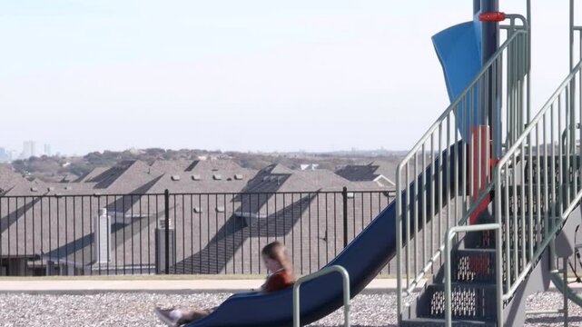 Sad Kid Slidding on a Playground Slide