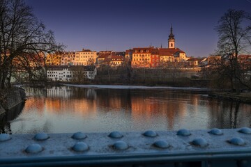 Royal city of Písek. Evening photo of the city. Bridge over the Otava River. Sunset. Quiet evening by the water. Beautiful photo.