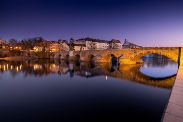 Royal city of Písek. Evening photo of the city. Bridge over the Otava River. Sunset. Quiet evening by the water. Beautiful photo.