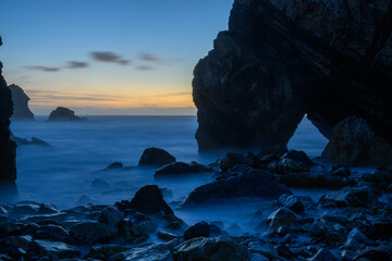 The Praia da Ursa beach on the Atlantic coast in Portugal with evening light and long exposure, Portugal