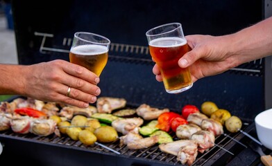 two glasses of beer against the background of a barbecue. recreation. nature.