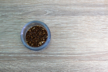 Glass Bowl of Coarse Grain Coffee Powder on Wooden Surface