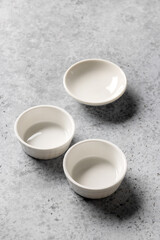 empty clean bowls on grey background