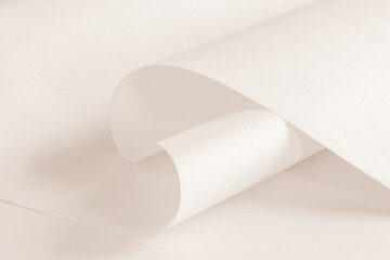 An unfolded sheet of paper in a warm neutral color in a light tone.