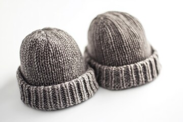 Two handmade knitted hats sit side by side, perfect for a cozy winter scene or as a decorative prop