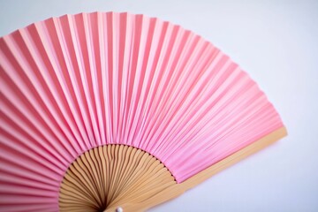 A detailed view of a pink fan sitting on a table
