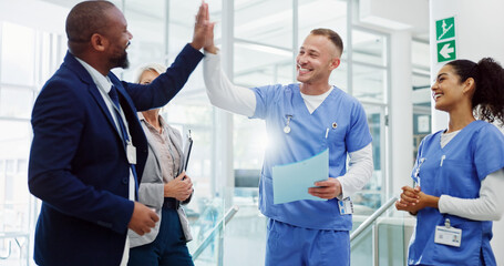 Doctors, high five and celebration with team at hospital for breakthrough, diversity or happy for...