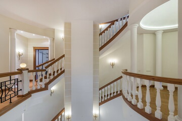 The floor of a luxurious mansion with stairs. The interior is decorated in neoclassical style.