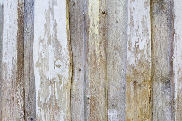 
an old wooden wall that has been painted with different colors and is partially peeling.