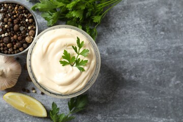 Bowl with mayonnaise on gray background