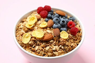 Delicious granola with berries on a color background
