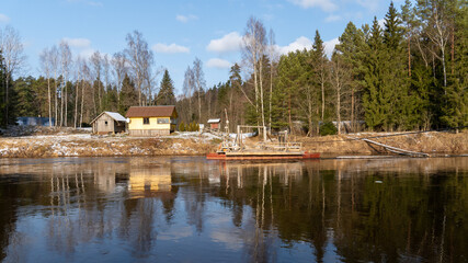 Obraz premium Rustic Wooden Cable Ferry Crossing a River in Winter. 07.02.2025. Ligatne. Latvia.