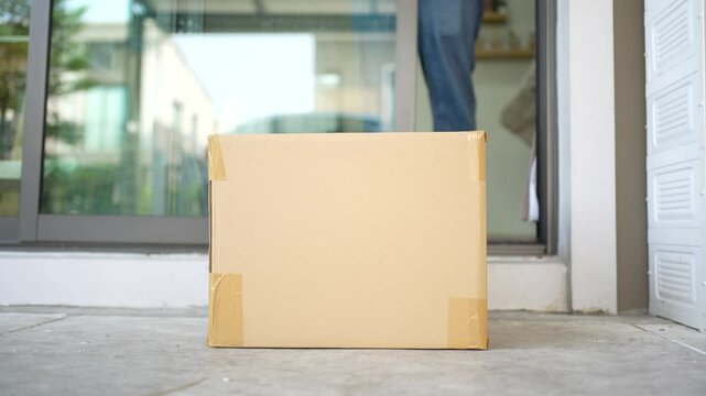 Delivery online shopping.Anonymous Man Walks out of the Front Door and Picks-up His Postal Parcel box