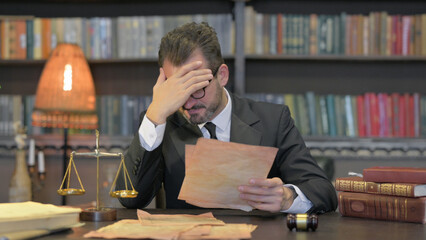 Tense Middle Aged Lawyer Shocked while Reading Court Orders in Office
