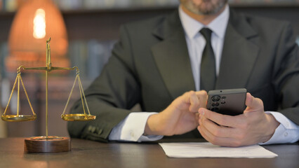 Close up of Male Lawyer Using Smartphone in Office