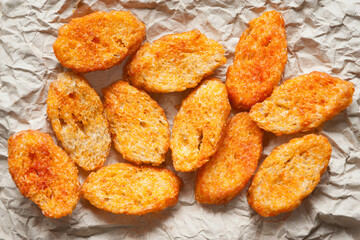 Rusks with spices. Fried croutons. Croutons on paper close-up