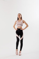 Obraz premium Model showcases activewear in minimalist studio setting during a wellness photoshoot
