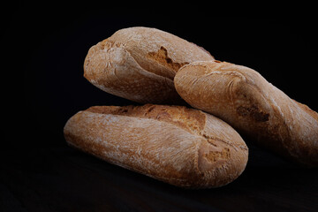 Two beautiful baguettes on a dark background. Art bread. Beautiful baguette.