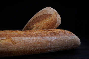 Two beautiful baguettes on a dark background. Art bread. Beautiful French baguette.