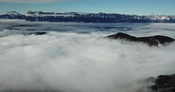 Alpes-Belledonne, a stunning view of a sea of clouds with distant mountain ranges in the background.