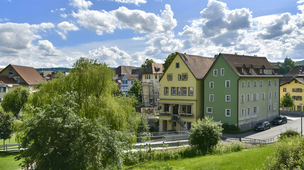 Colorful houses in a quaint European village on a sunny day, idyllic scenery. For tourism brochure, postcard, or travel website
