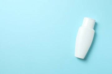 Cosmetic bottle on blue background 