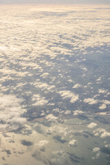 London, United Kingdom, England, a view of the ocean from an aeroplane window with clouds in the sky