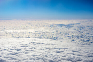View of clouds from airplane window, clouds in a blue sky