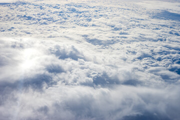 View of clouds from airplane window, clouds in a blue sky