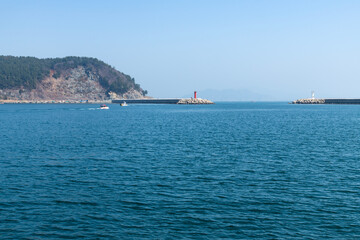 speed boat and lighthouse at the harbor