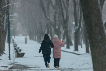 Winter Park. Walking around the city during heavy snowfall. Winter landscape in Ukraine. White snow in the city park. Cold weather, time of year. Snow-covered ground on the city street. Dnipro city