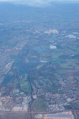 Aerial view of London through early morning clouds at golden hour sunrise through the clouds